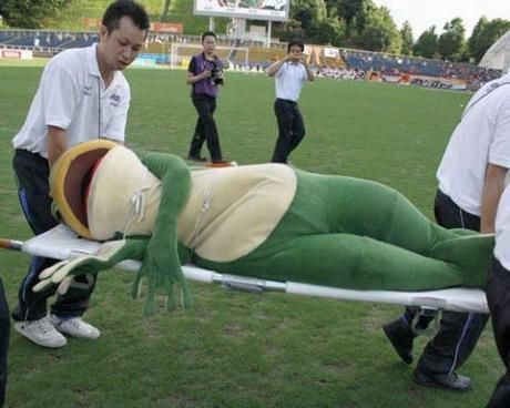 A mascot frog on a stretcher.